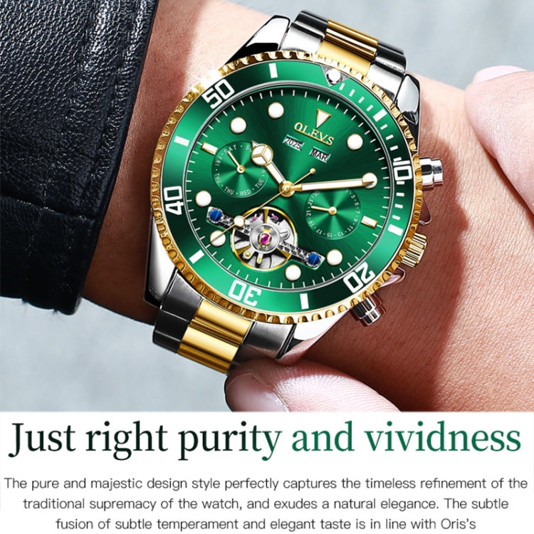 Green dial mechanical watch on wrist with black leather strap and two-tone bracelet