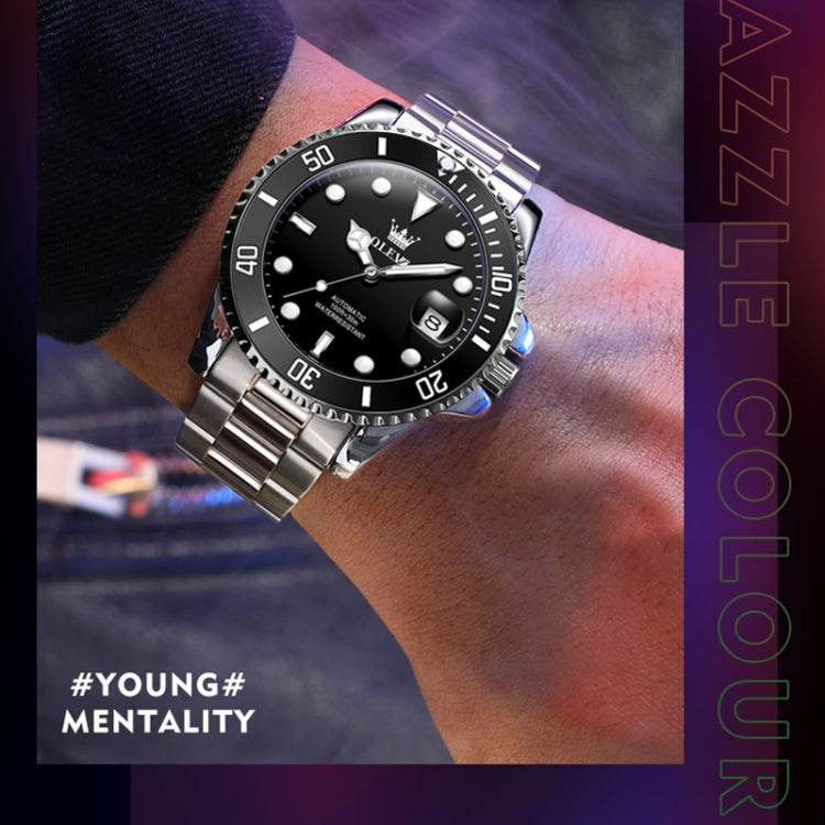Men's mechanical waterproof wristwatch on wrist, black dial and luminous hour marks, steel band