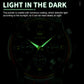 Men's quartz watch dial glowing in low light, luminous hands and markers