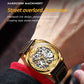 Men's gold hollow mechanical watch with black leather strap on wrist, close-up