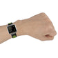 Silicone sports watch strap on wrist in black with green accent perforation pattern