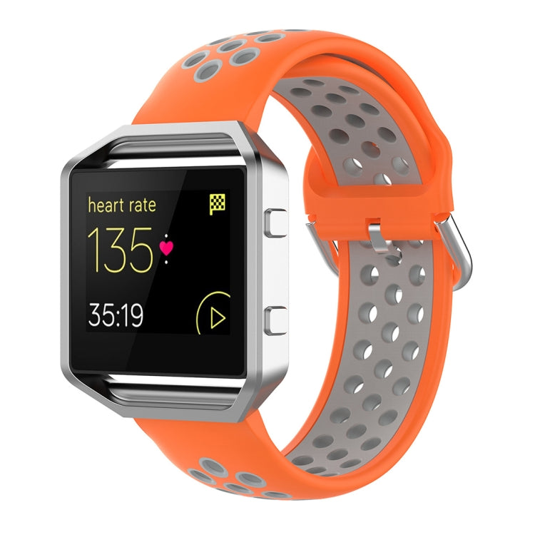 Fitbit silicone watch strap in orange with perforated sporty design and pin buckle