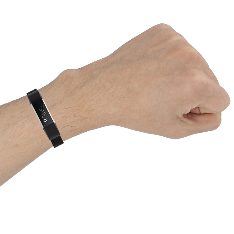 Black mesh metal watch strap worn on wrist, side profile
