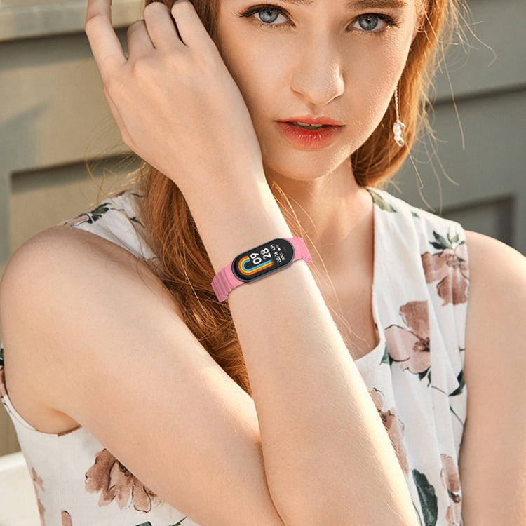 Pink silicone watch band on wrist with fitness smartwatch face visible