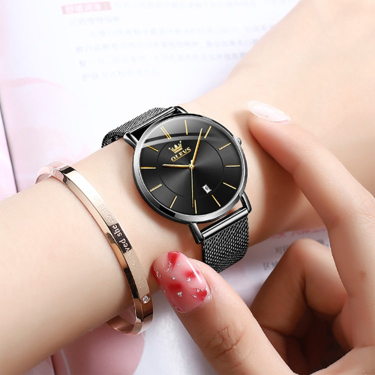 Black dial ladies quartz watch on wrist with black mesh steel strap