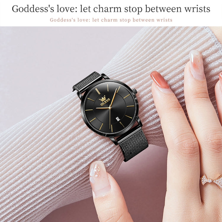 Black dial quartz watch with black mesh steel strap worn on wrist