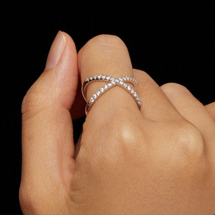 Dual-layer moissanite ring with crisscross silver band on finger