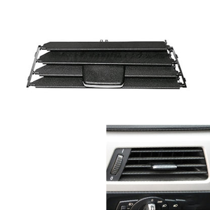 Black car A/C air outlet panel grille with central control tab and side vents