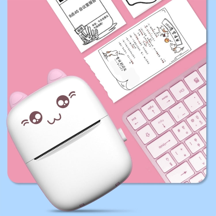 Pink mini Bluetooth thermal printer with cat face, dispensing a printed label