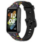 Black silicone smartwatch band with rainbow dot confetti pattern and buckle-style clasp