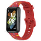Red silicone smartwatch band with rainbow dot confetti pattern and buckle-style clasp