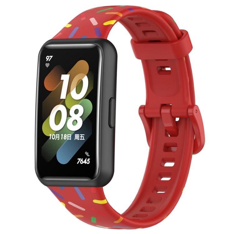 Red silicone smartwatch band with rainbow dot confetti pattern and buckle-style clasp