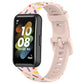 Light pink silicone watch band with rainbow dot confetti pattern and buckle-style clasp