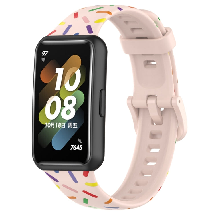 Light pink silicone watch band with rainbow dot confetti pattern and buckle-style clasp