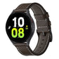 Brown leather watch band with buckle, stitched edges, and perforated adjustment holes
