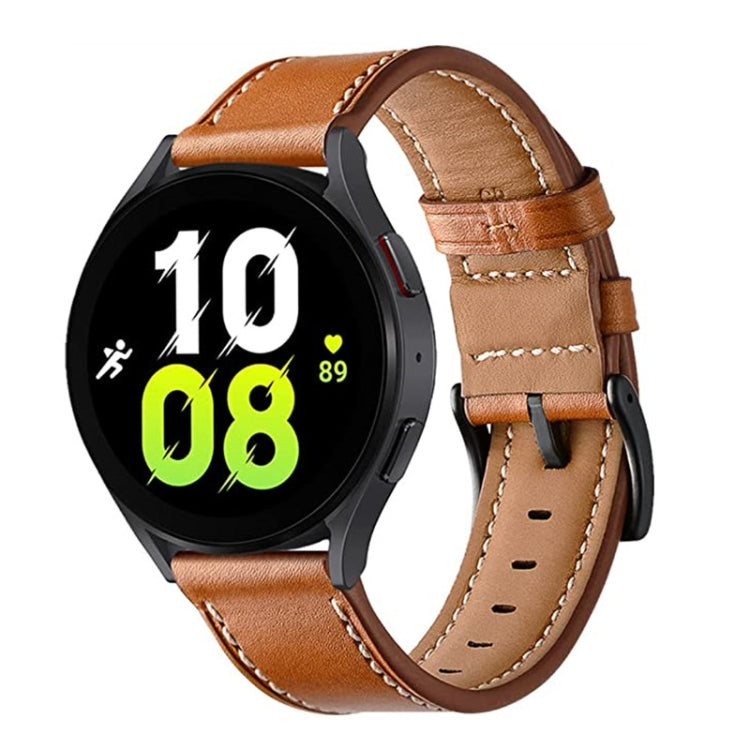 Tan leather watch band with metal buckle, stitched holes, and secure strap loop