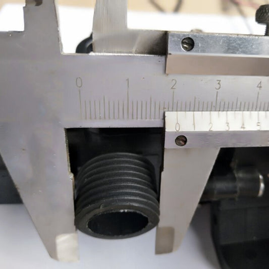 Threaded pump outlet fitting with ribbed connector, shown with caliper measurement