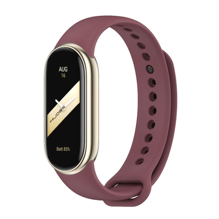 Purple silicone smartwatch band with black fitness tracker face and vented strap holes