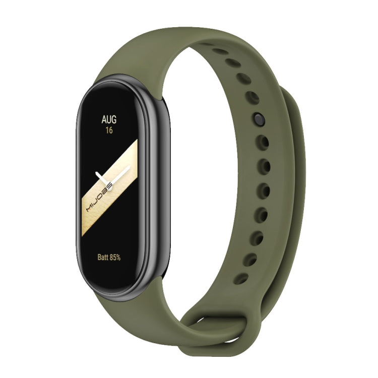 Olive green silicone smartwatch band with black fitness tracker face and vented strap holes