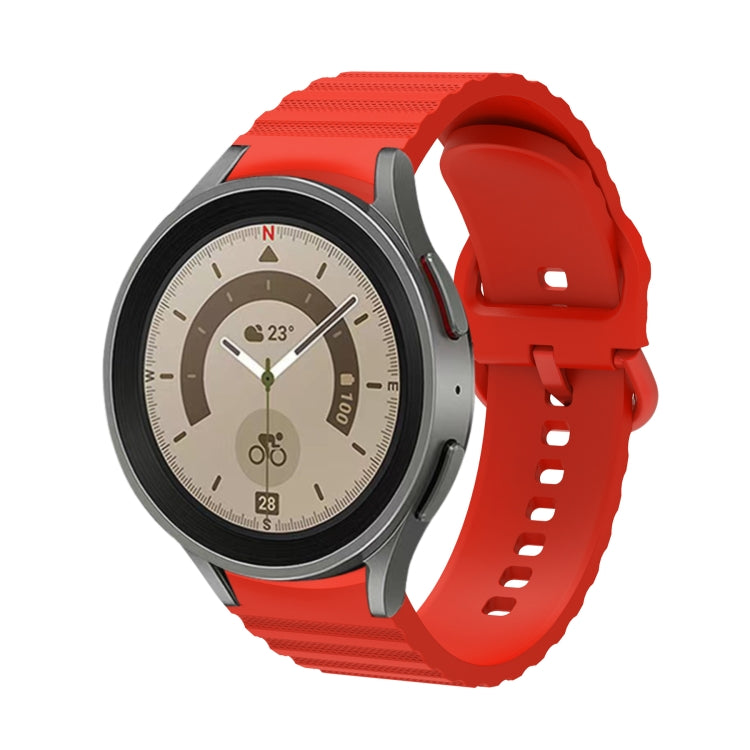 Orange silicone watch band with wave dotted texture and buckle, front view