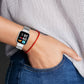 Gray Milan metal watch band with protective frame on a wrist
