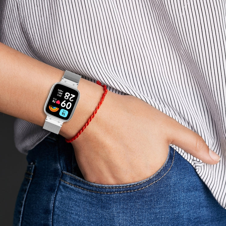 Gray Milan metal watch band with protective frame on a wrist