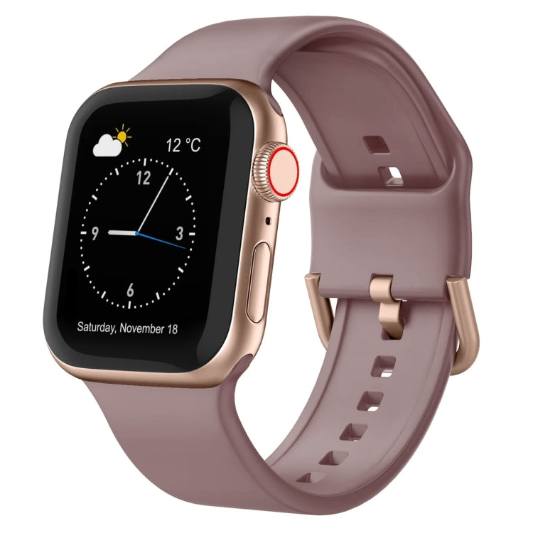 Silicone watch band with pin buckle, mauve pink strap with multiple adjustment holes.