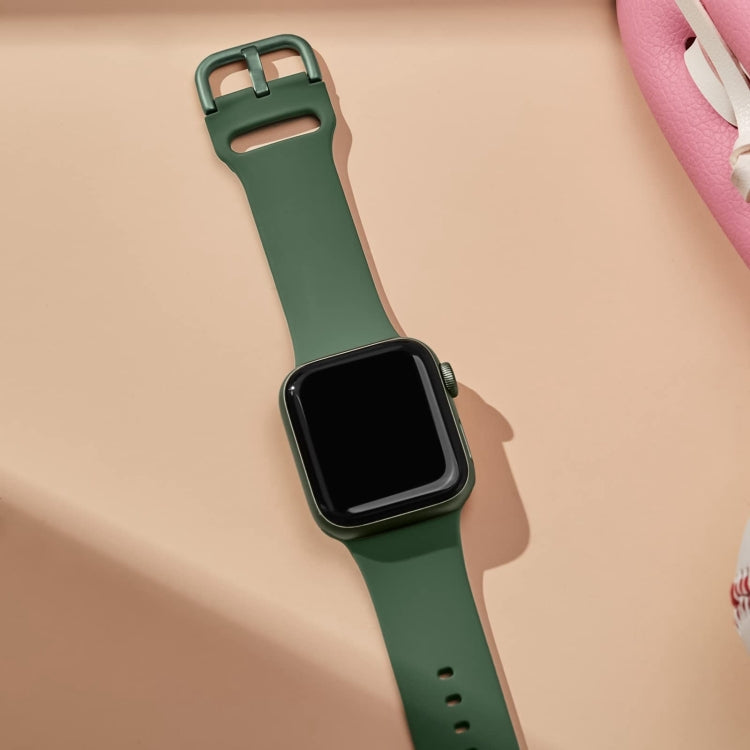 Silicone watch band with pin buckle, clover green, worn on wrist with Apple Watch