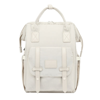 Light gray mommy backpack with top handle, front pockets, and snap-front flap.