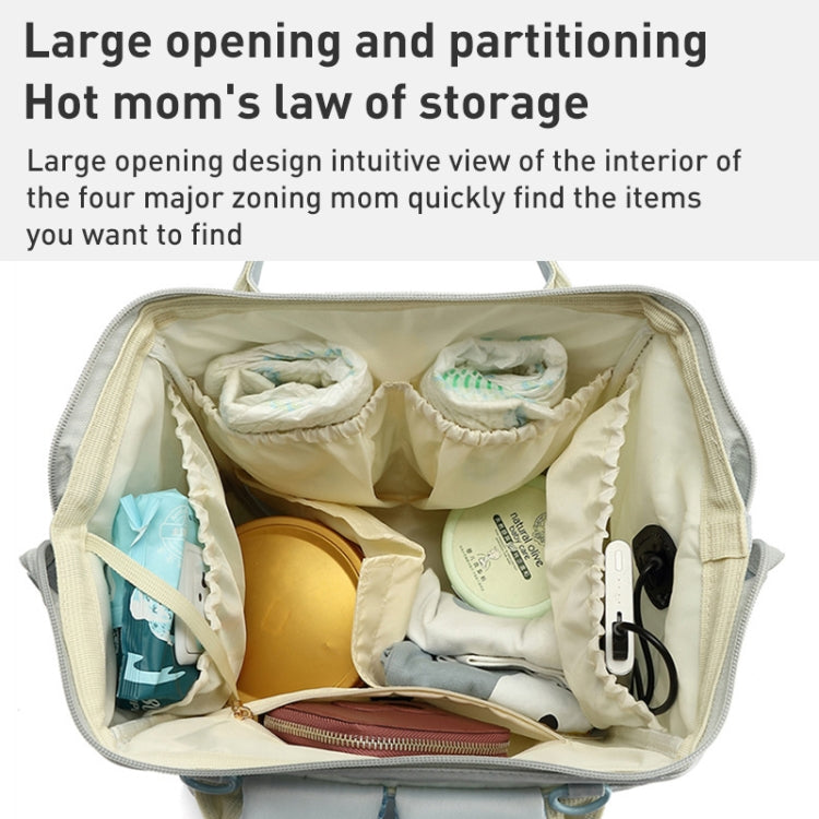 Open light blue mommy backpack interior with multiple compartments for baby essentials.