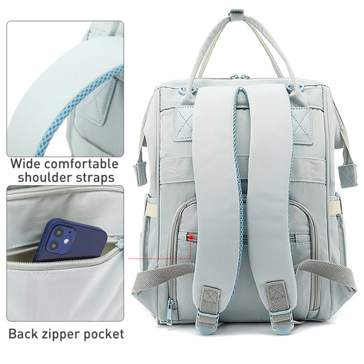 Large light gray baby care backpack with blue accents, front pockets, and adjustable shoulder straps