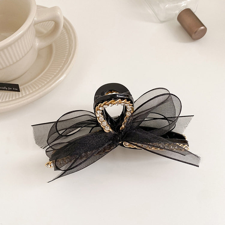 Black mesh bowknot hair gripper with rhinestones and gold-tone chain detail