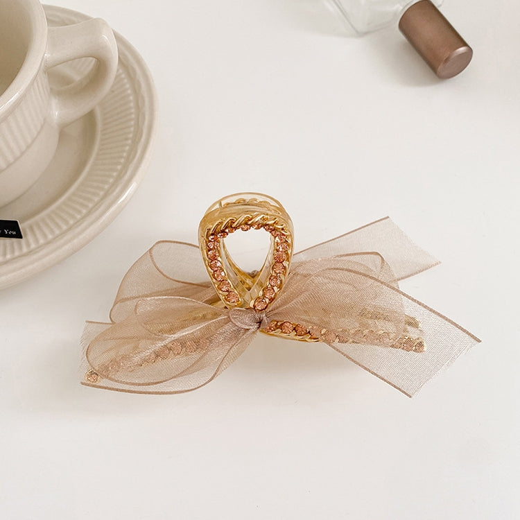 Champagne mesh bowknot hair gripper with rhinestones and gold-tone chain detail