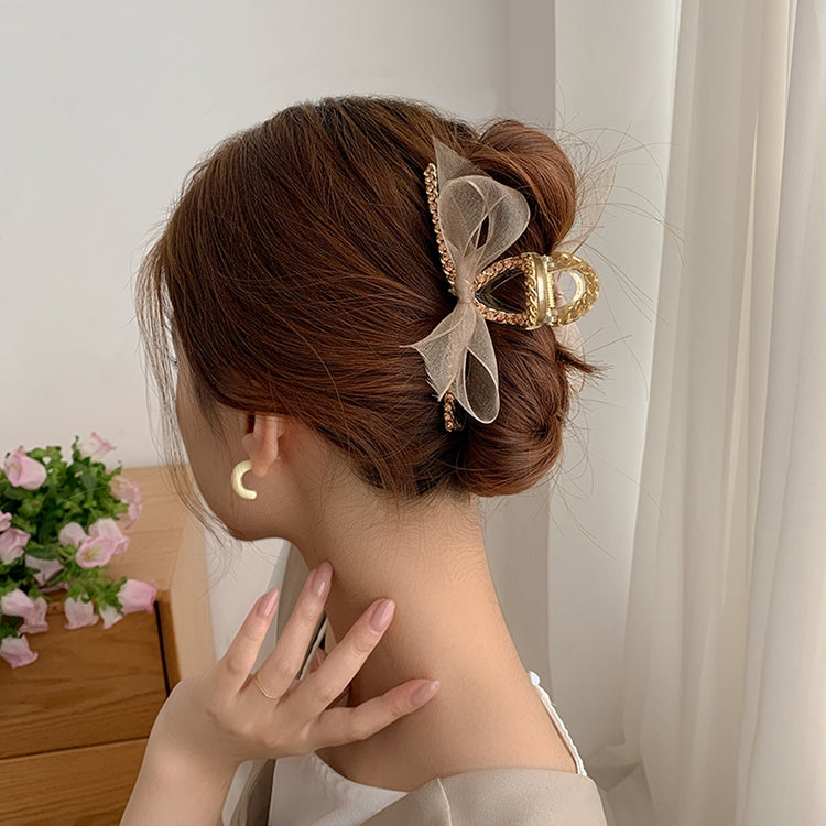 Champagne gold bowknot rhinestone hair gripper clipped to hair