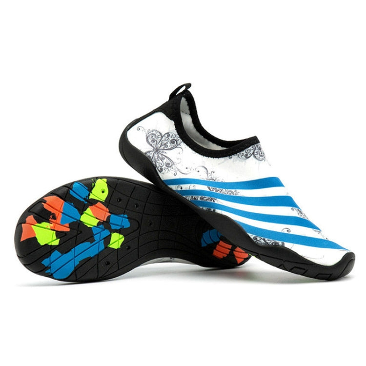Black-and-white slip-on swim shoes with blue striped print and grippy patterned sole