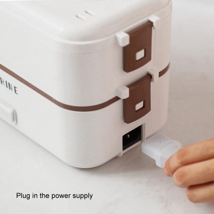 White electric lunch box with brown trim and plugged-in power cord