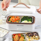 White heated lunch box open with two divided food compartments and brown base