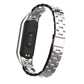Silver stainless steel double-spring strap with clasp, shown with black fitness band