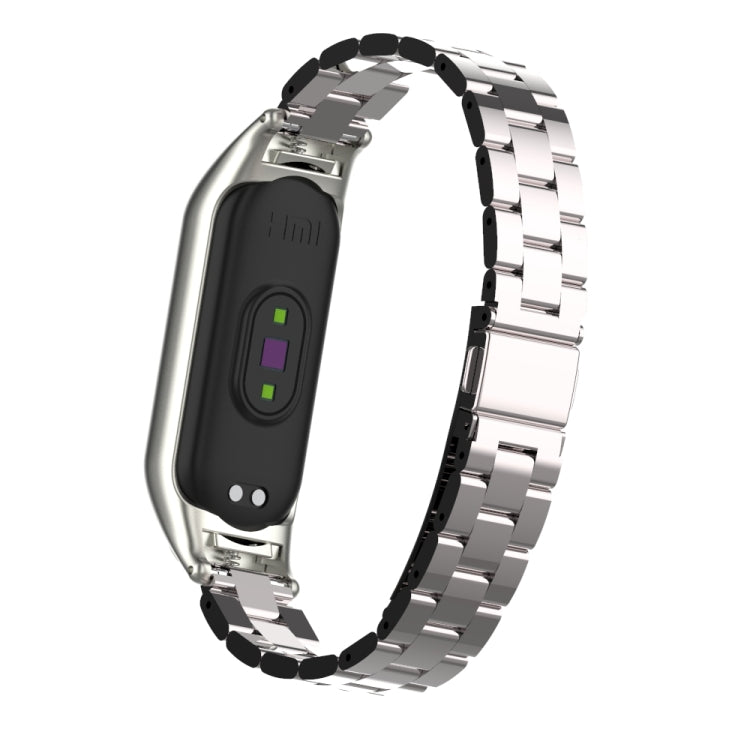 Silver stainless steel double-spring strap with clasp, shown with black fitness band