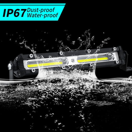 Black LED work light bar with two LED strips, shown with water spray