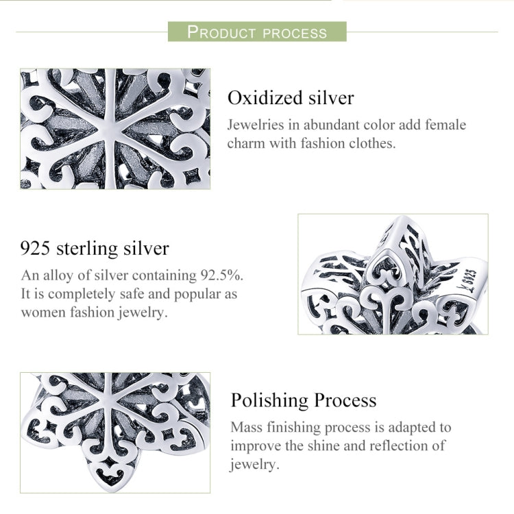 Sterling silver snowflake charm bead close-up with ornate filigree details