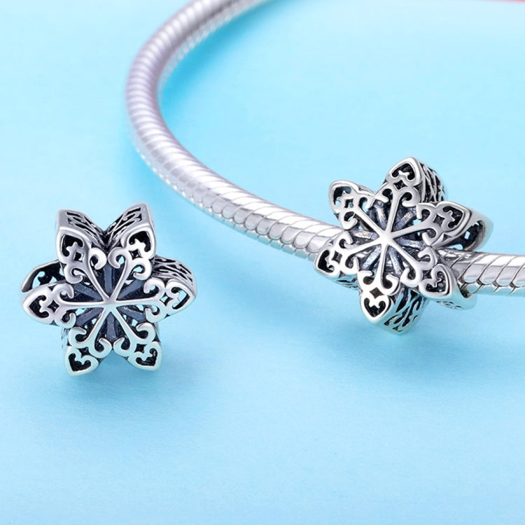 Sterling silver snowflake charm bead on snake-chain bracelet, with clasp detail