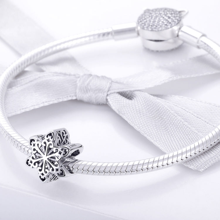 Silver snake-chain bracelet with sterling snowflake charm bead and white tassel tie