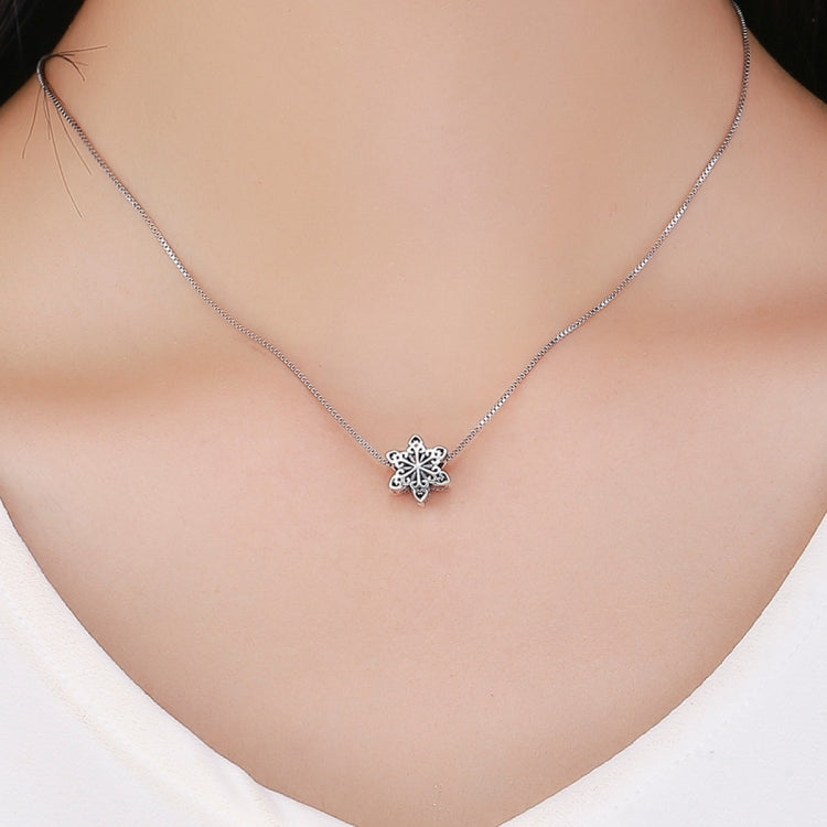 Sterling silver snowflake charm bead necklace pendant on collarbone