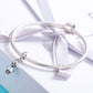 Silver charm bracelet with ribbon bow and robot boy bead pendant