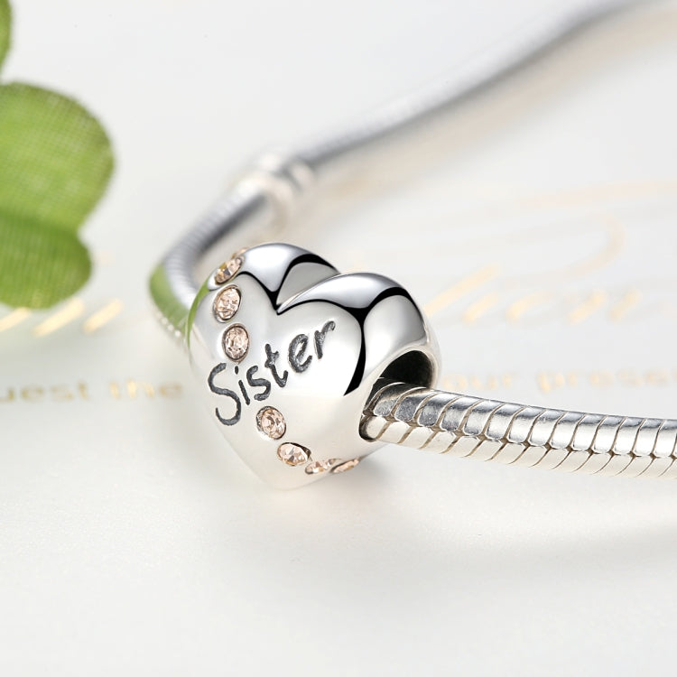 Silver heart charm bead on bracelet with 'Sister' text and round crystal details
