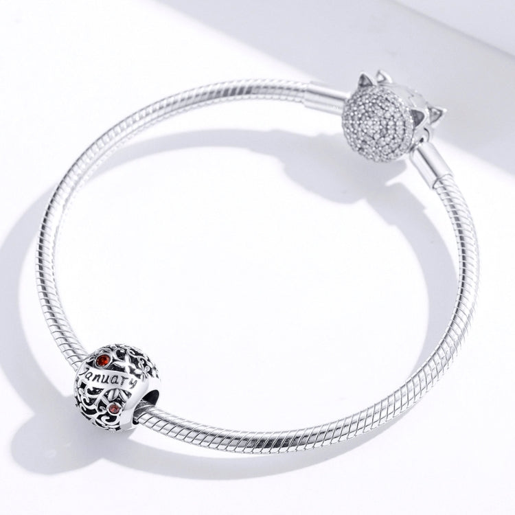 Sterling silver snake bracelet with January charm bead and rhinestone cat accent