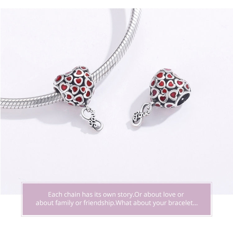 Two silver bracelet charms with red heart enamel pattern and hanging connector