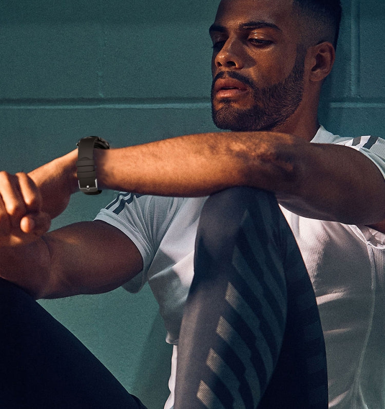 Black smartwatch on a man’s wrist with round display