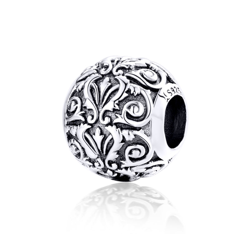 Sterling silver charm bead with retro flower swirl texture and dark center opening